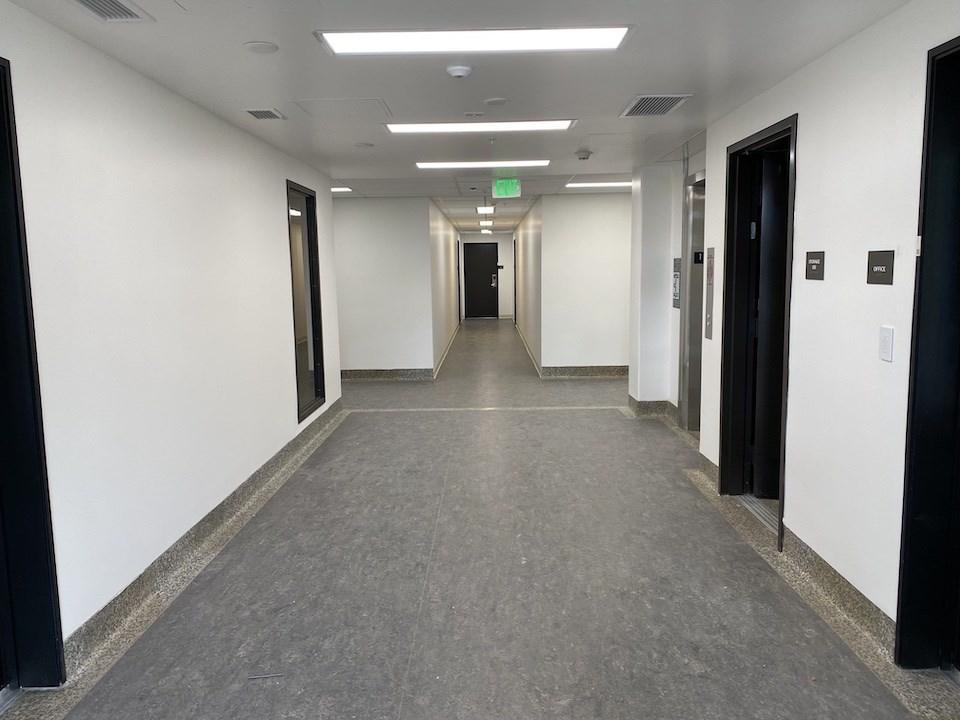 Renovated Building 205 interior lobby, looking west showing restored flooring. 